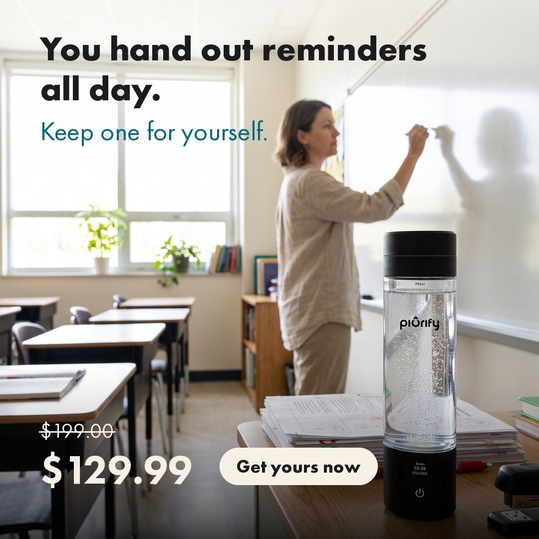 Teacher at a whiteboard with the bottle on her desk