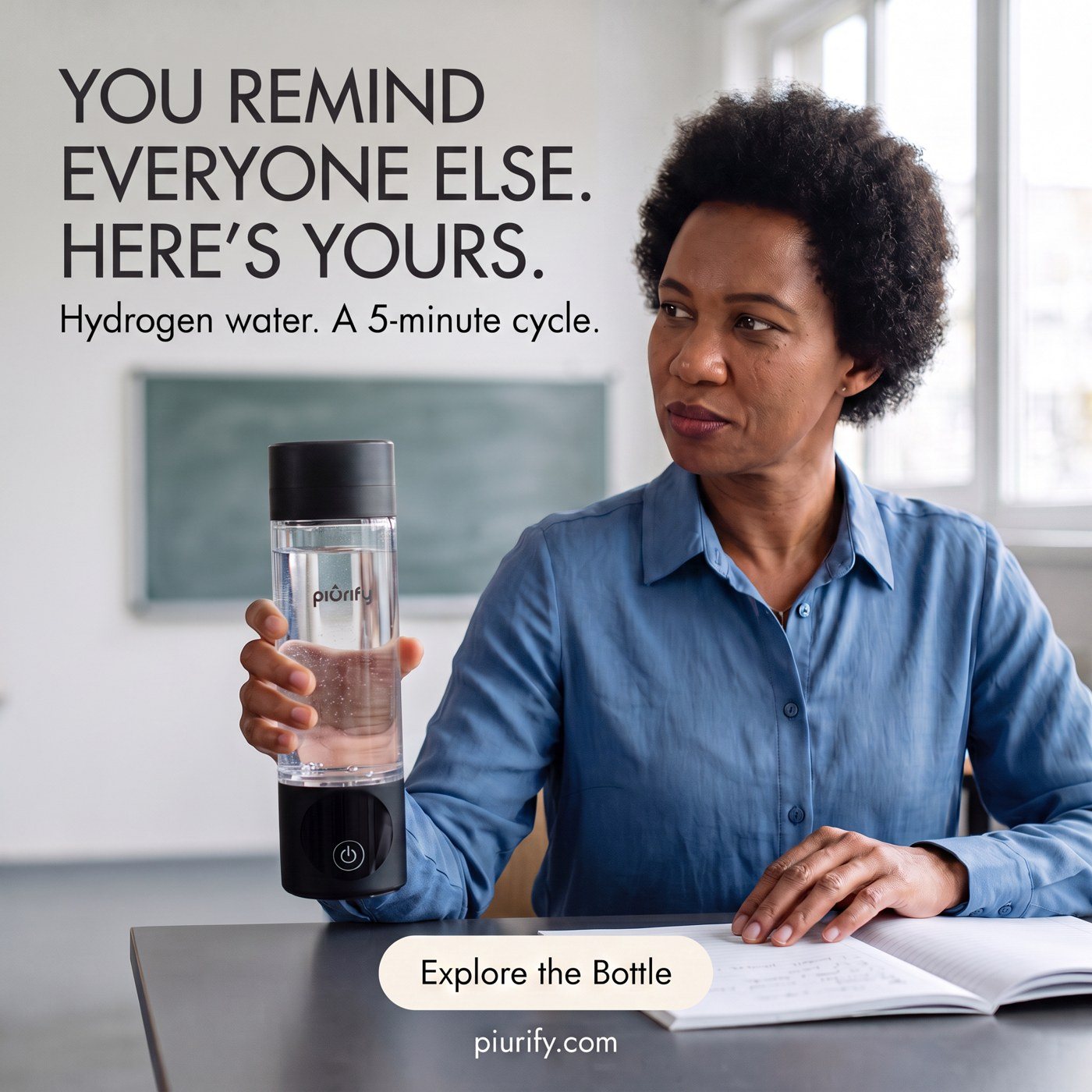 Teacher at her desk holding the bottle
